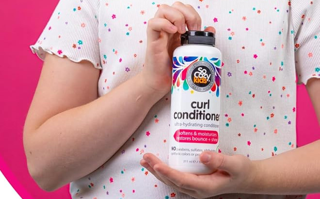 A Child Holding the So Cozy Curl Conditioner