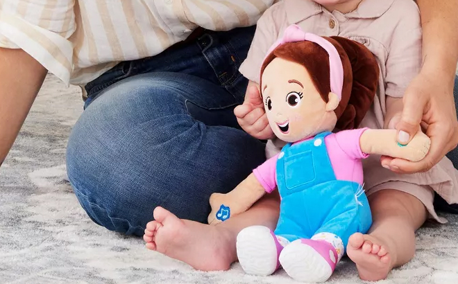 A Child Playing with the Ms Rachel Speak Sing Doll