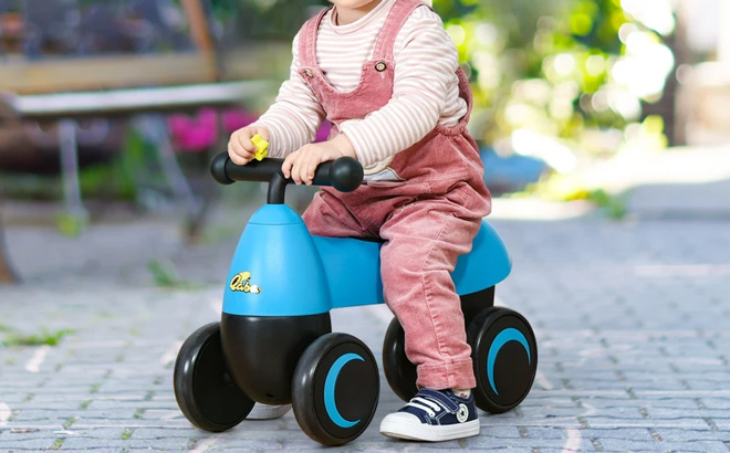 A Child Riding a Qaba Ride on Walking Bike