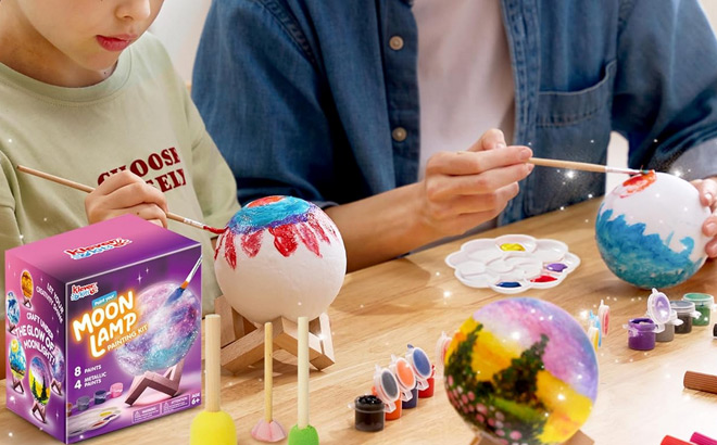 A Child and an Adult Using a Paint Your Own Moon Lamp Kit