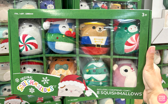 A Hand holding Christmas Ornament Squishmallows Holiday Design 8 Pack Box