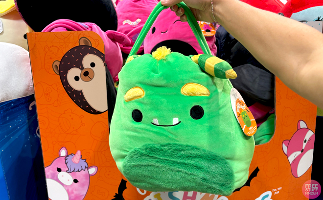 A Hand holding a Squishmallow 16 Inch Jumbo Treat Pail in Green Color