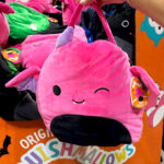 A Hand holding a Squishmallow 16 Inch Jumbo Treat Pail in Pink Color