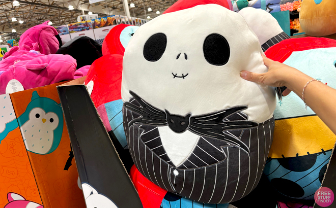 A Hand holding a Squishmallows 20 Inch Jack Skellington Plush