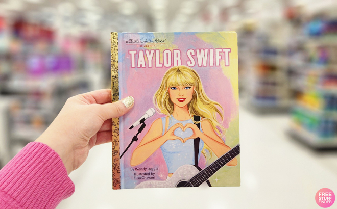 A Hand holding a Taylor Swift A Little Golden Book Biography