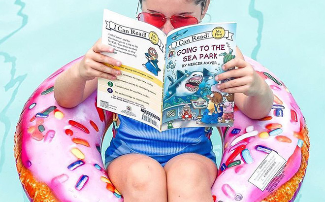 A Kid Reading a Book on a Floatie