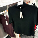 A New Day Mock Turtleneck Pullover Sweater Hanging on a Shelf