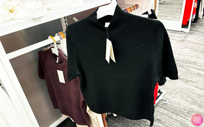 A New Day Mock Turtleneck Pullover Sweater Hanging on a Shelf