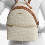 A Person Carrying the Michael Kors Sheila Medium Logo Backpack in White