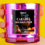 A Person Holding Forever Fizzies Caramel Bourbon Pear Candle