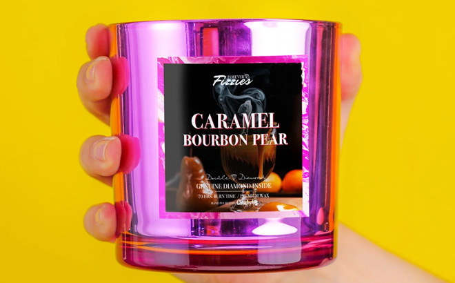 A Person Holding Forever Fizzies Caramel Bourbon Pear Candle