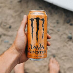 A Person Holding Monster Energy Java Monster Salted Caramel Coffee with Energy Drink