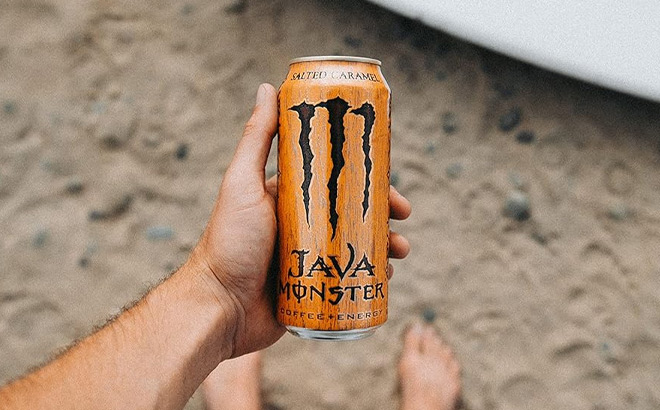 A Person Holding Monster Energy Java Monster Salted Caramel Coffee with Energy Drink