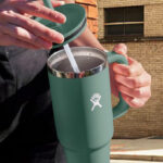 A Person Holding a Hydro Flask Travel Tumbler in Fir Color