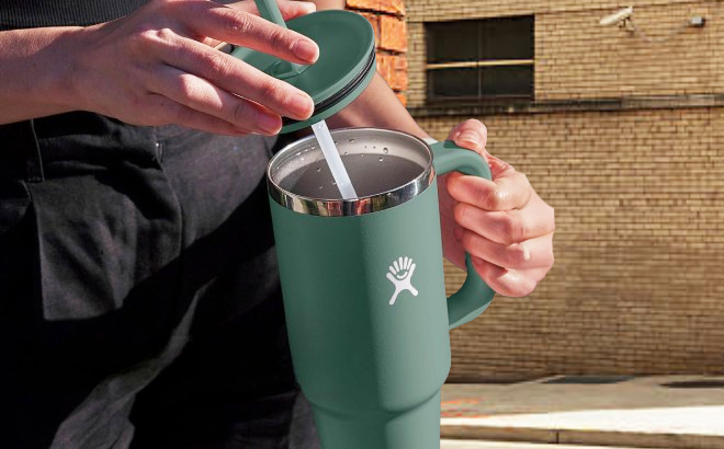 A Person Holding a Hydro Flask Travel Tumbler in Fir Color