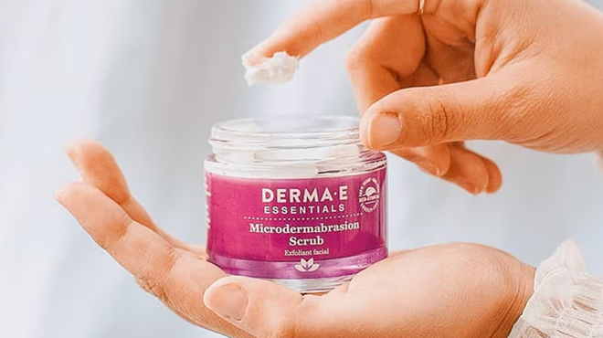 A Person Holding a Jar of Derma E Dead Sea Salt Microdermabrasion Scrub