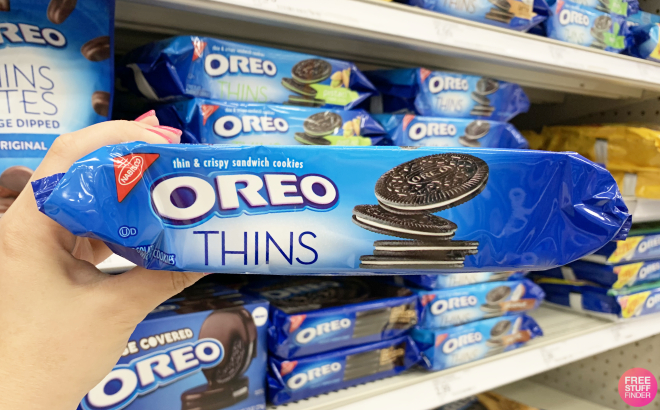 A Person Holding a Pack of Oreo Thins Chocolate Sandwich Cookies