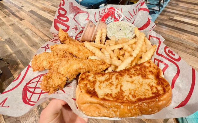 A Person Holding a Raising Canes Box Combo