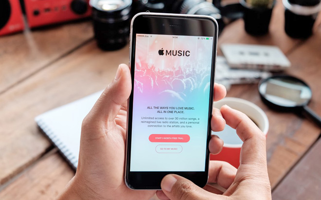 A Person Holding an iPhone Showing Apple Music