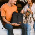 A Person Holding the Insulated Lunch Bag in Black in a Car