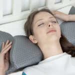 A Person Lying on a Cervical Pillow on a Bed