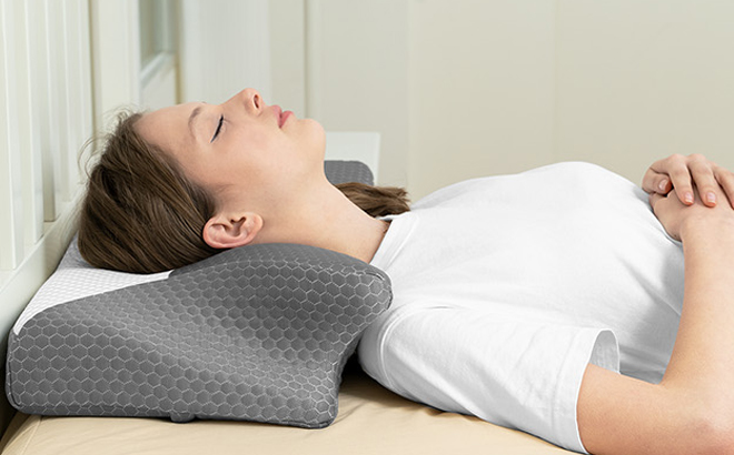 A Person Lying on the Cervical Pillow on a Bed