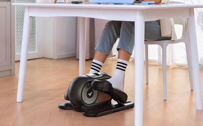 A Person Using Merach Under Desk Elliptical Machine