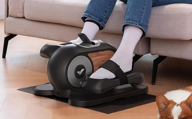 A Person Using Under Desk Elliptical Machine