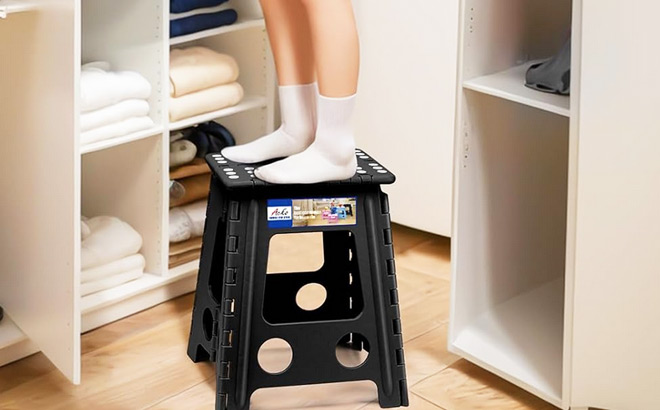 A Person Using a Step Stool to Reach Higher Areas of a Closet