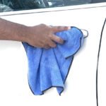 A Person Using the Auto Drive Coral Fleece Multi Purpose Microfiber Towel