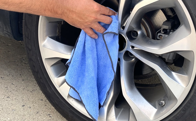 A Person Using the Auto Drive Coral Fleece Multi Purpose Microfiber Towel in Blue