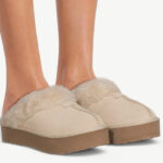 A Person Wearing Joyspun Womens Suede Platform Clog Slippers