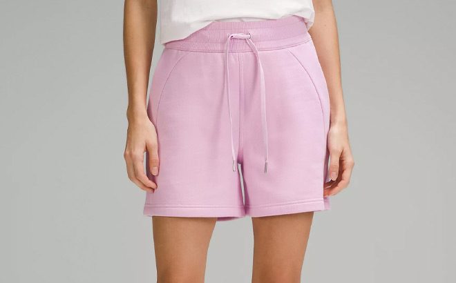 A Person Wearing Lululemon Scuba High Rise Short in Vitapink Color