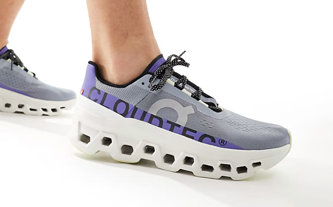 A Person Wearing On Cloudmonster Running Shoes in Mist Blueberry Color