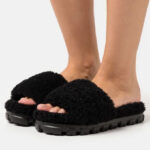 A Person Wearing UGG Cozetta Curly Womens Slippers