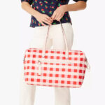 A Person holding a Kate Spade Chelsea Gingham Weekender Bag