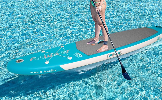 A Person standing on a Funwater Inflatable Paddle Board in Dark Green Color