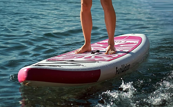 A Person standing on an Inflatable Paddle Board