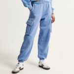 A Person wearing Abercrombie Fitch Essential Oversized Cargo Sunday Sweatpants in Blue Color