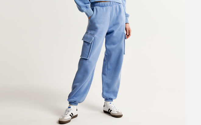 A Person wearing Abercrombie Fitch Essential Oversized Cargo Sunday Sweatpants in Blue Color