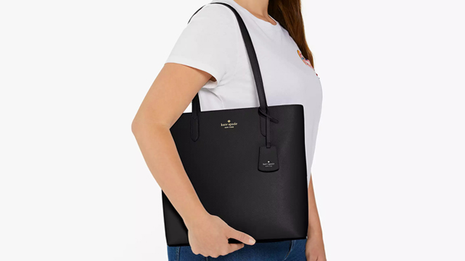 A Person wearing Kate Spade Brynn Tote Bag in Black Color