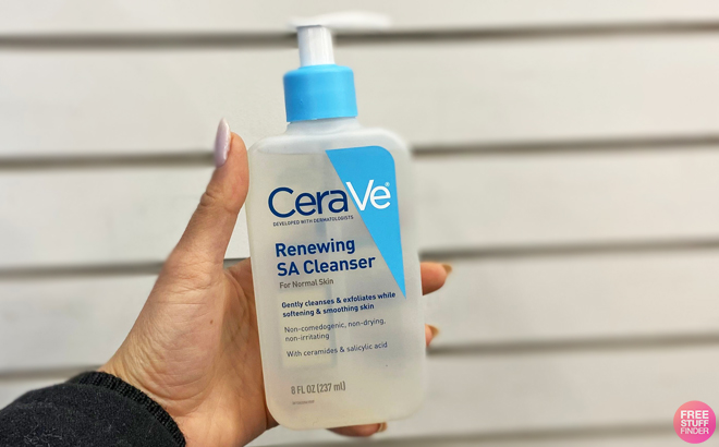 A Perswon Holidng a Bottle of CeraVe Renewing SA Cleanser