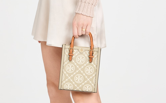 A Woman Holding Tory Burch Mini T Monogram Contrast Embossed Tote