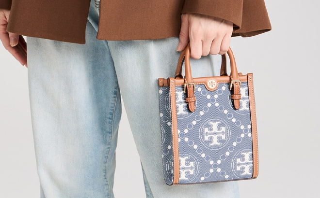 A Woman Holding Tory Burch Monogram Denim Mini Tote