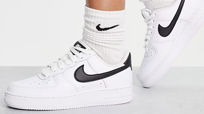 A Woman Wearing Nike Air Force 1 07 Sneakers in White and Black