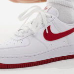 A Woman Wearing Nike Air Force 1 Sneakers in White and Red