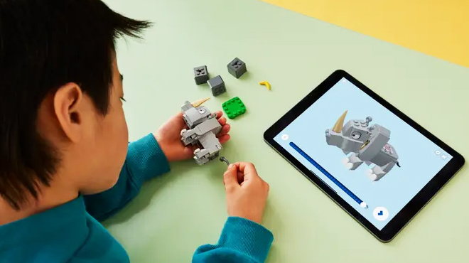 A child playing with LEGO Rambi the Rhino Expansion Set