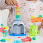 A child playing with a Play Doh Swirlin Smoothies Toy Blender Playset