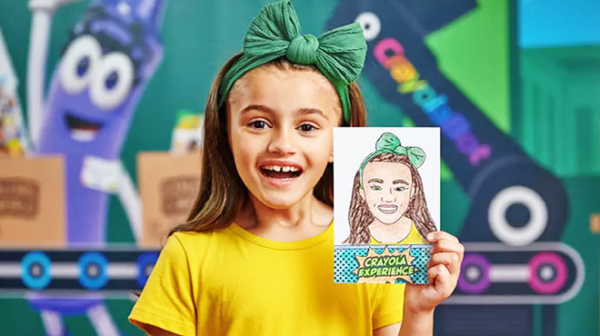 A girl holding a Crayola Experience Cartoon Bot sketch of herself