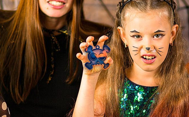 A girl holding a Halloween Pop Fidget Toy